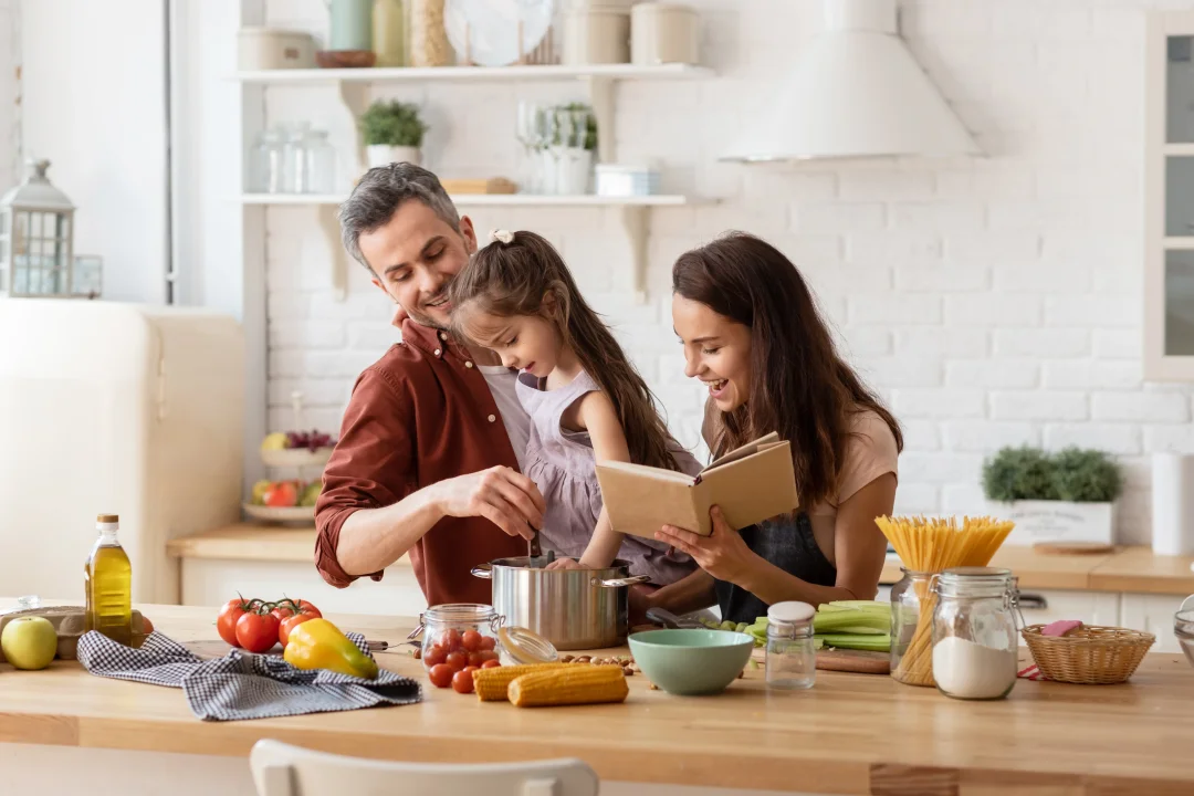 A family is in the kitchen together, cooking