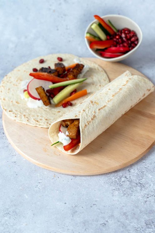 Tzatziki-Teriyaki Wraps auf einer Holzplatte